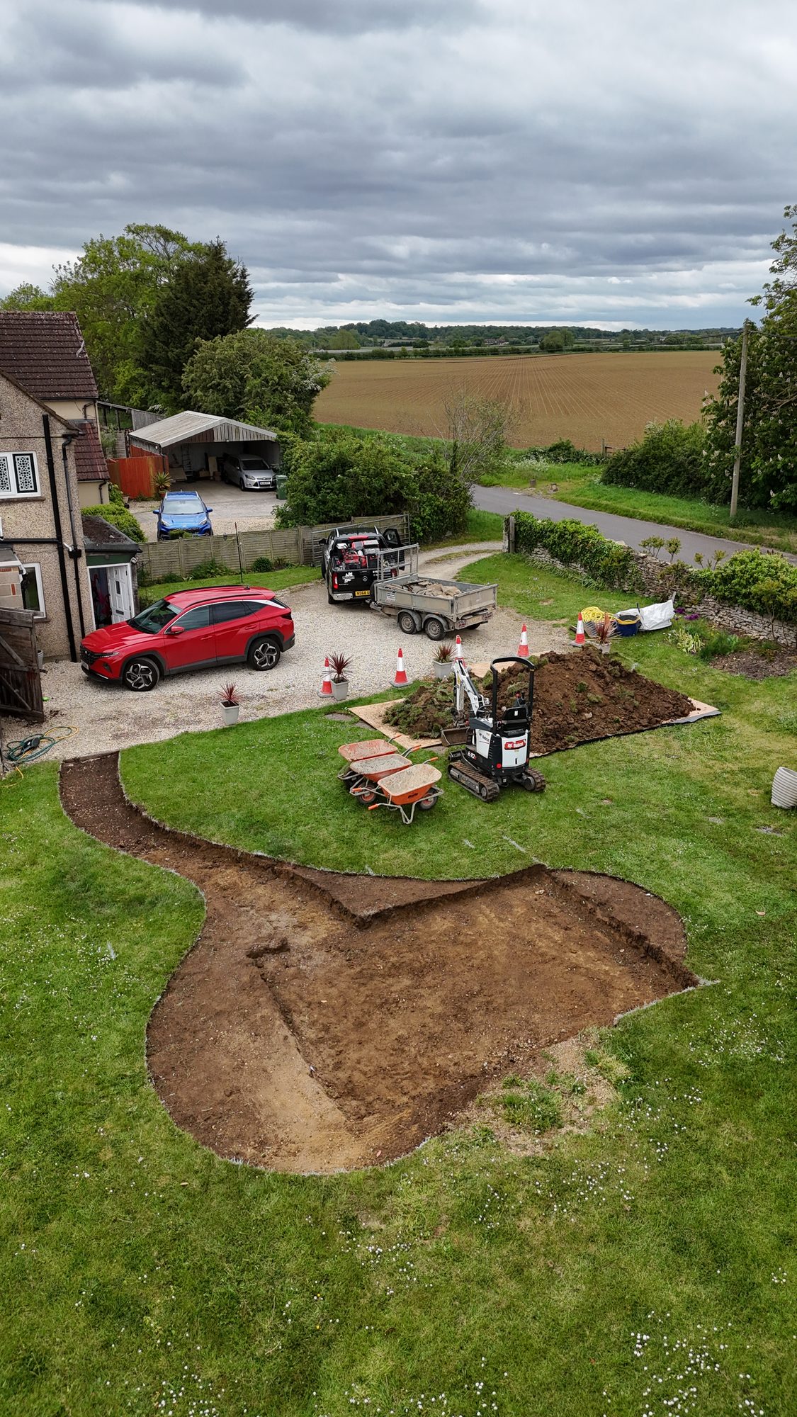 Aerial of garden groundwork in progress with a mini-digger