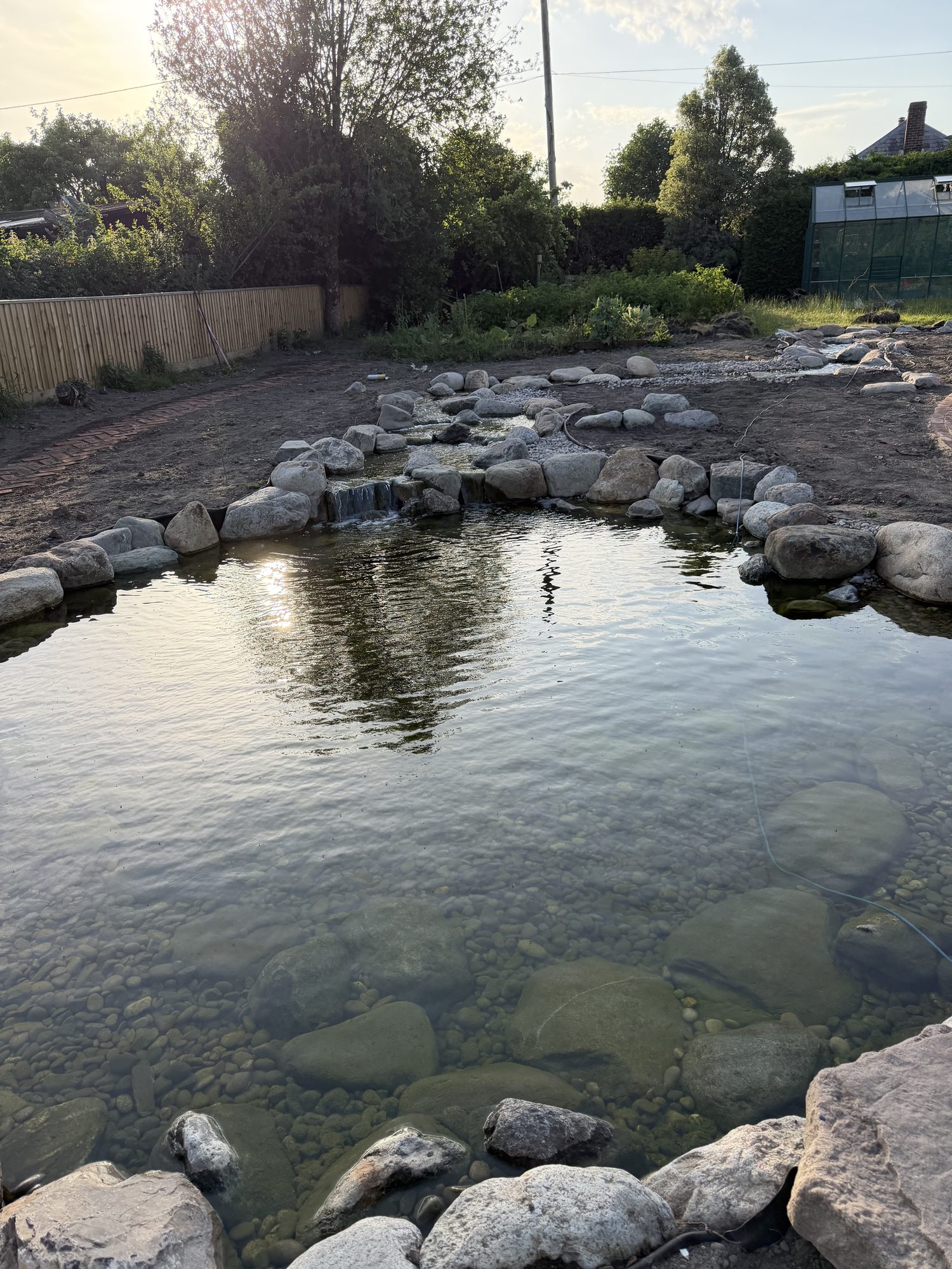 Wildlife pond with a feeder stream cascading in over rocks